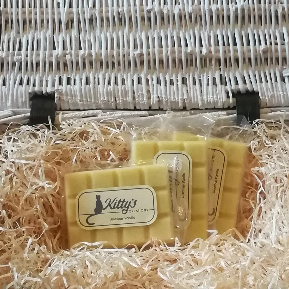 Three hand-made rectangular Wax Melts. Each is coloured a light refreshing yellow, are pictured resting in a basket of straw. A rich and creamy blend of Madagascan vanilla pods, nutmeg and crushed nuts, whipped to a delicious blend, better than any ice-cream you can imagine.