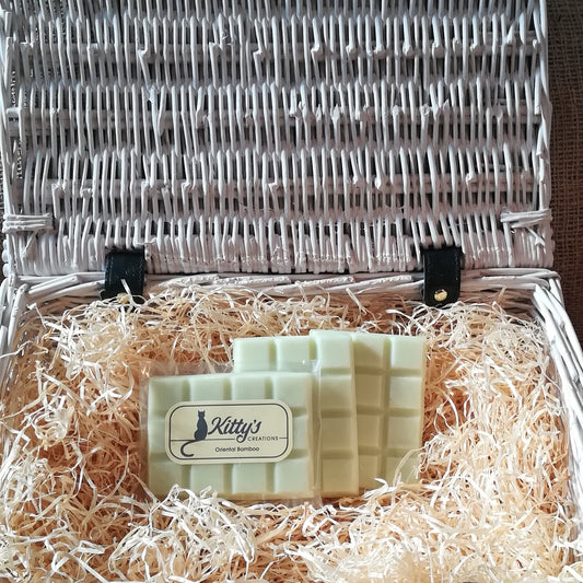 Three hand-made rectangular Wax Melts. Each is coloured a jungle inspired pale green like the new growth shooting upwards, and resting in a basket of straw. This is a delicate fragrance that glides over a room to relax and calm as you are carried into the jungle.