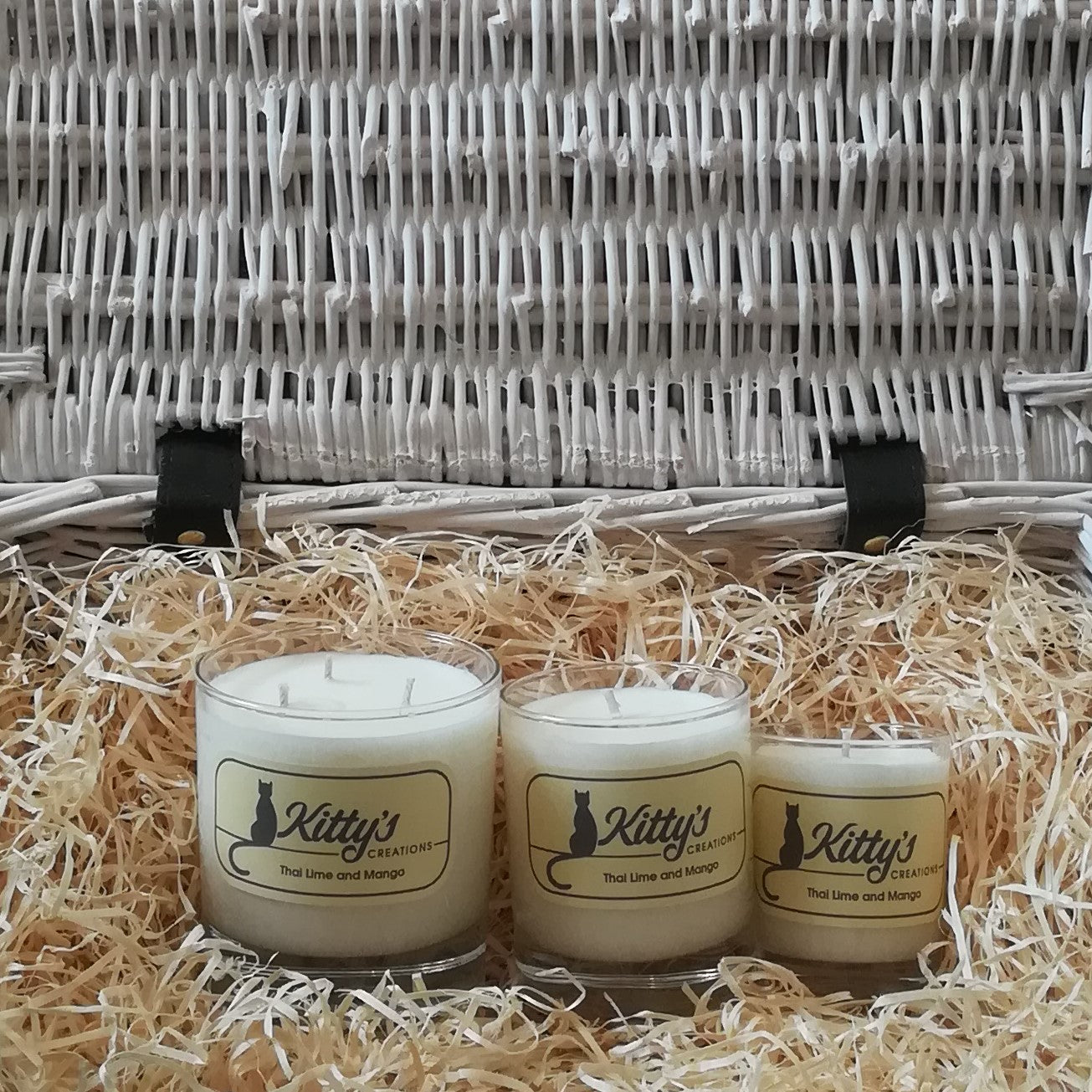 Three glass tumblers, one large, one medium, and one smaller are filled with soy wax, pictured in a basket of straw. These candles are the perfect gift. Each reveals a scent which is a vibrant mix of aromas, taking you back to those warm humid days and the sounds of night-time crickets on the trip you will never forget.