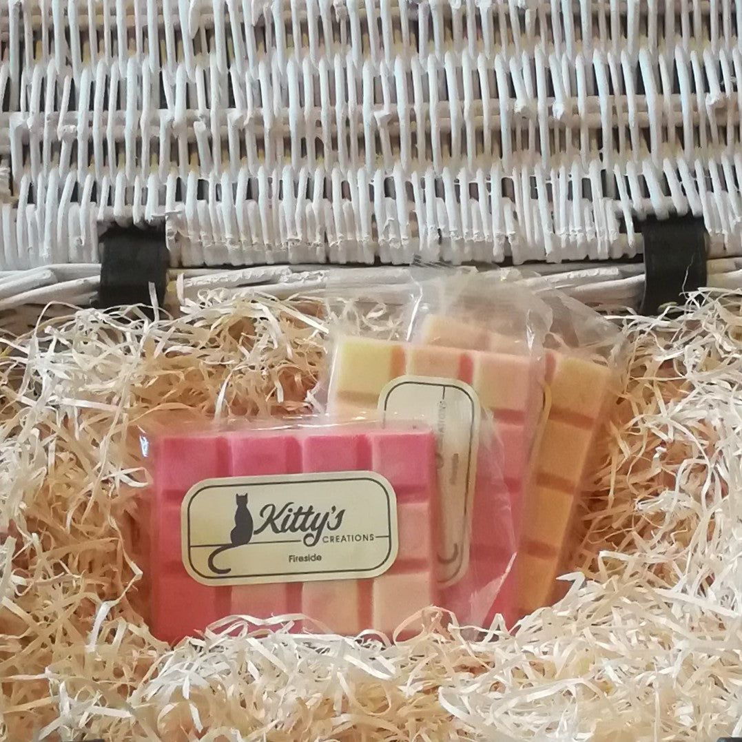 Three hand-made rectangular Wax Melts. Each is coloured flame pink, merging to a white-hot yellow, resting in a basket of straw. This fragrance transports you to your perfect fireside with bergamot, lemon, spices, red cedar, massoia wood and amber.